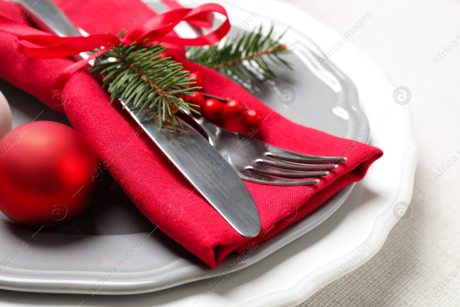 Photo of Festive table setting with beautiful dishware and Christmas decor on white background