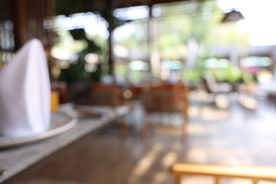 Photo of Blurred view of comfortable cafeteria with furniture