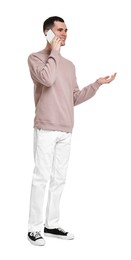 Handsome young man talking on phone against white background