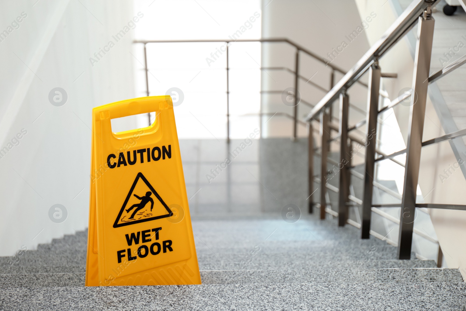 Photo of Safety sign with phrase Caution wet floor on stairs. Cleaning service