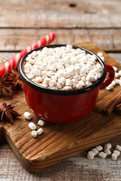 Tasty hot chocolate with marshmallows on wooden table, closeup