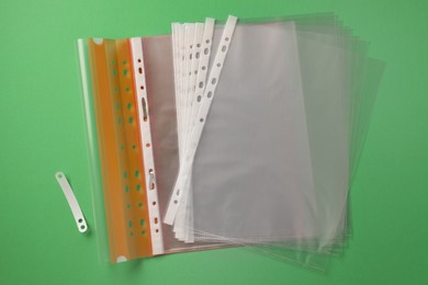 Photo of File folder with punched pockets on green background, flat lay