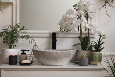 Photo of Stylish sink and beautiful houseplants in bathroom. Interior design