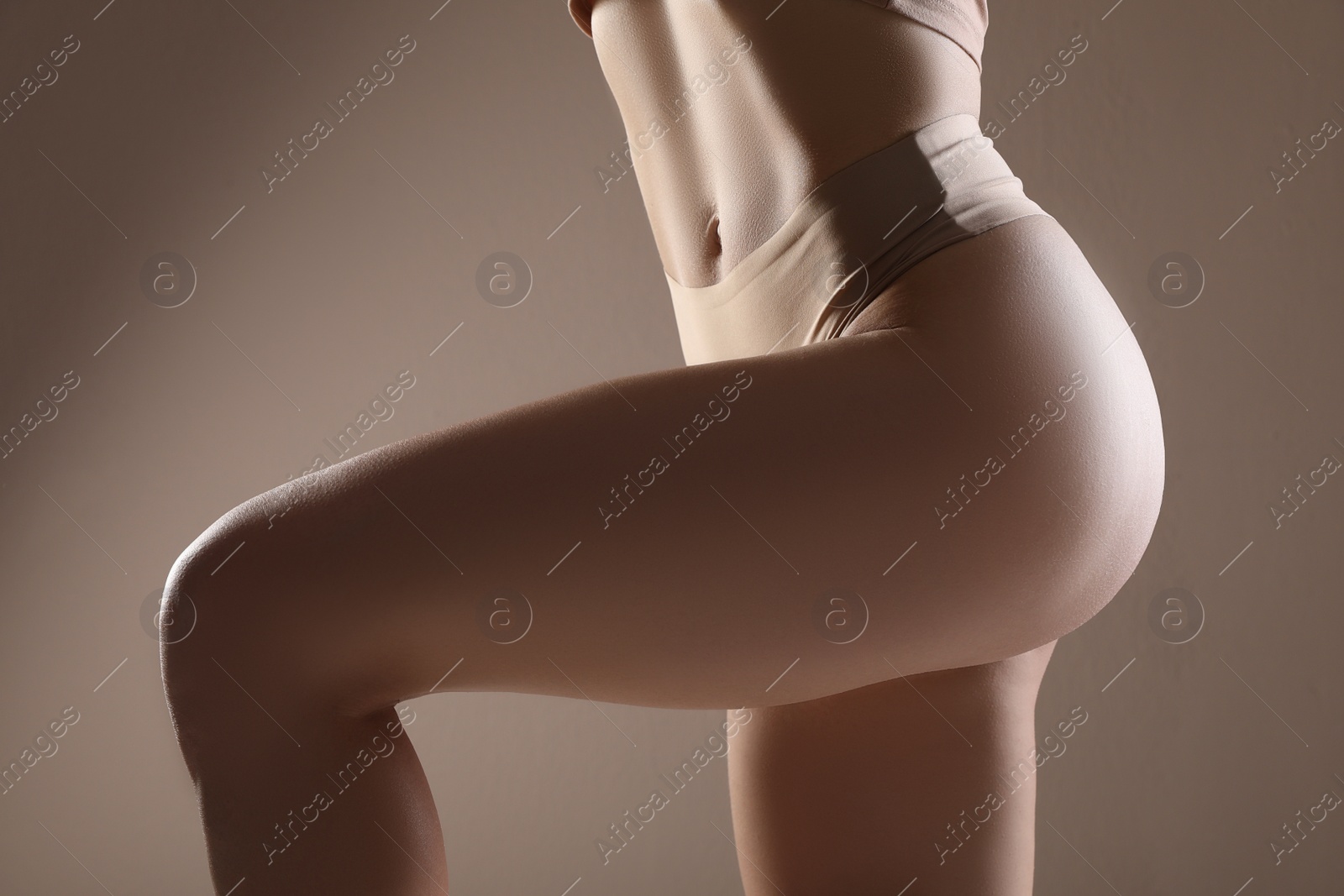 Photo of Closeup view of slim woman in underwear on beige background. Cellulite problem concept