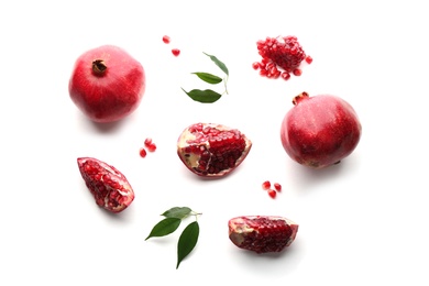 Photo of Ripe pomegranates on white background, flat lay. Delicious fruit