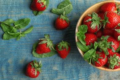 Flat lay composition with ripe red strawberries and mint on wooden background