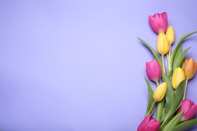 Photo of Beautiful tulips on violet background, flat lay. Space for text