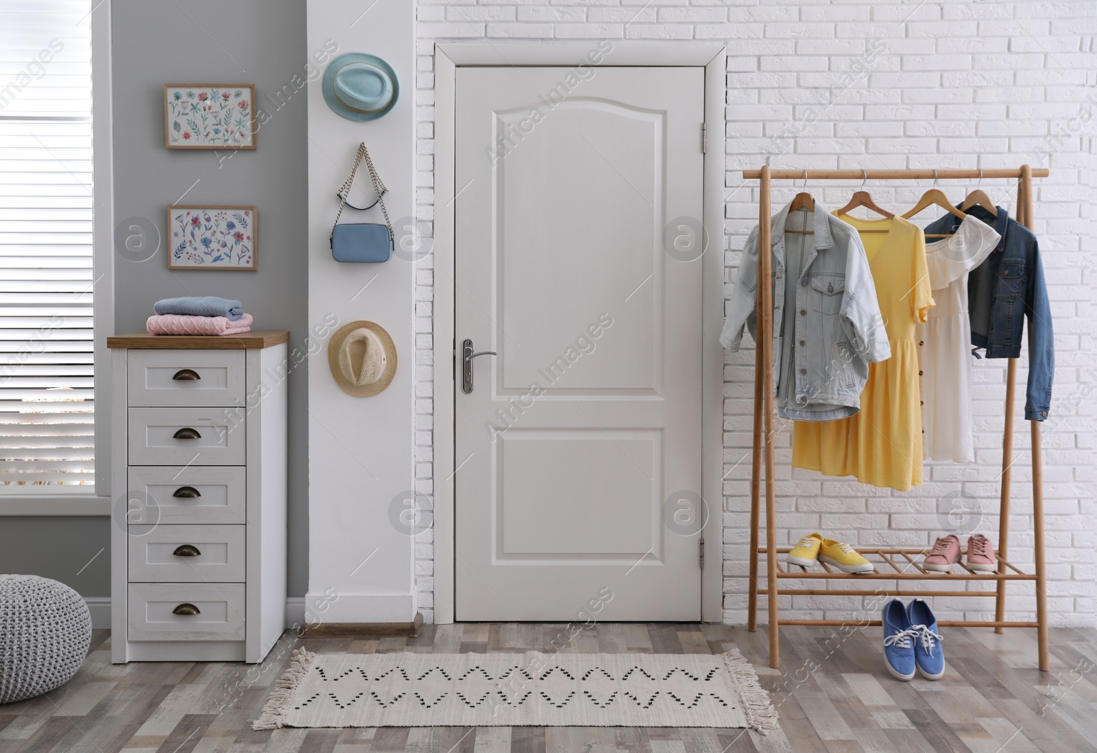 Photo of Hallway interior with stylish furniture, clothes and accessories