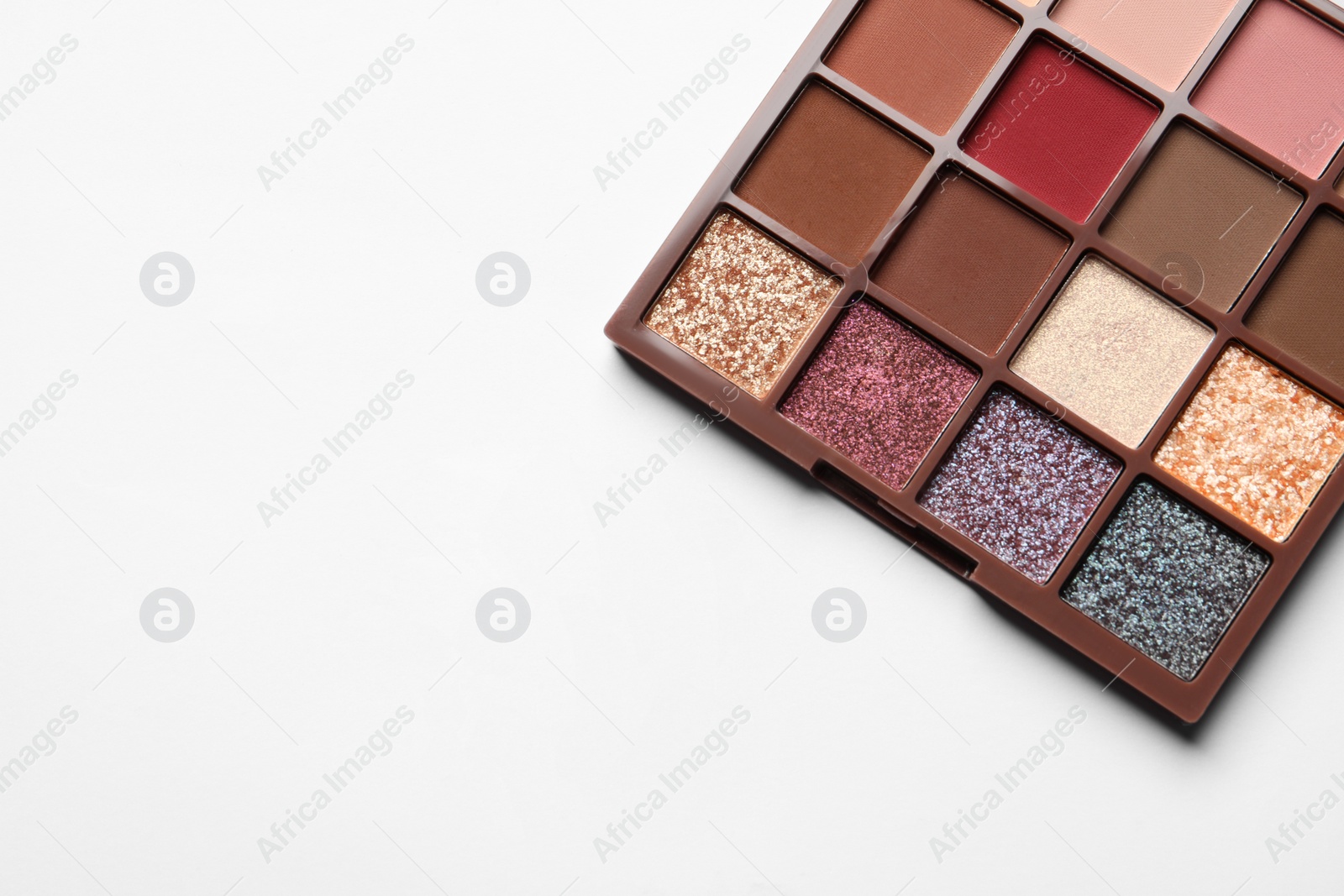 Photo of Beautiful eye shadow palette on white table, top view. Space for text