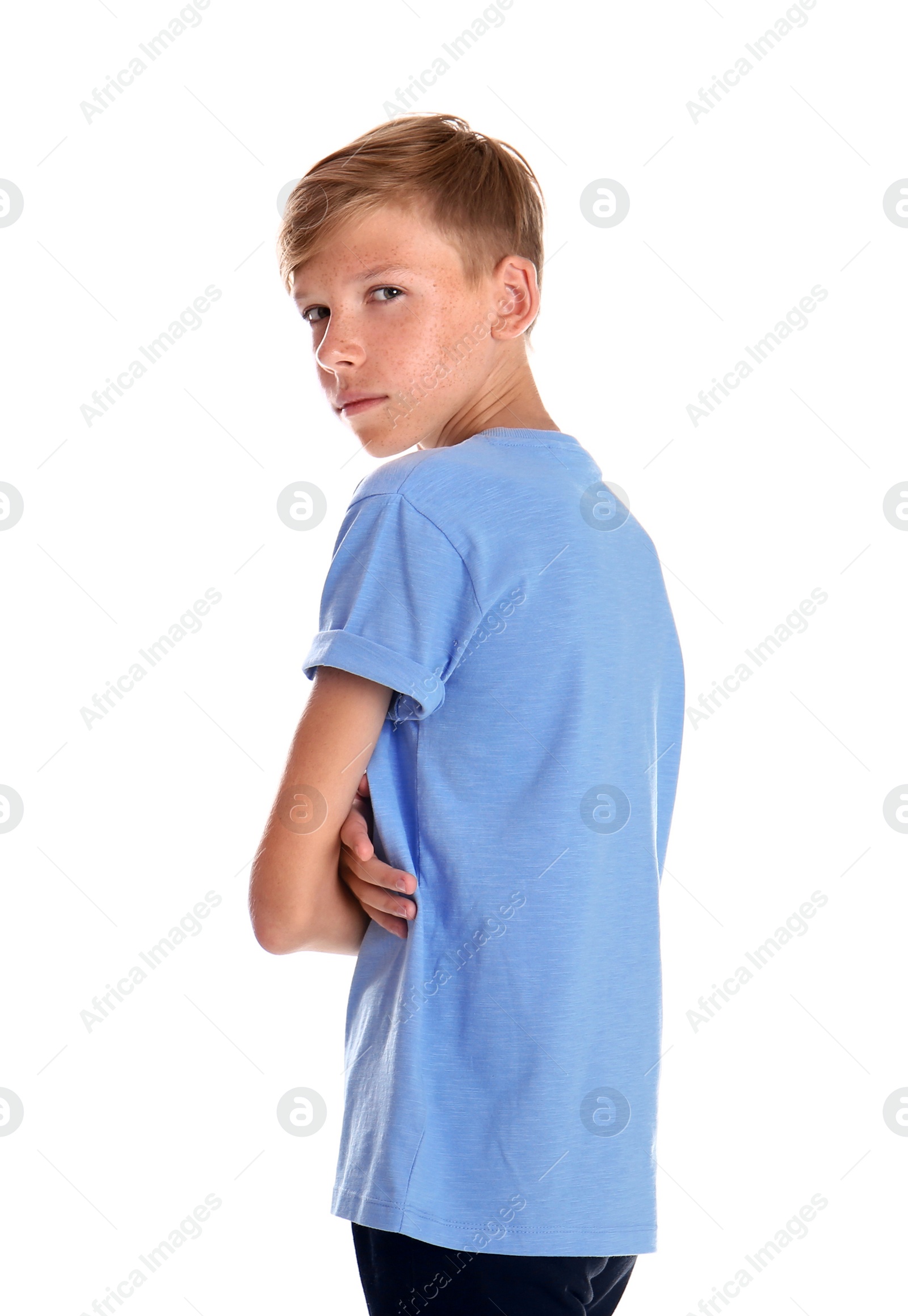 Photo of Portrait of young boy standing against white background