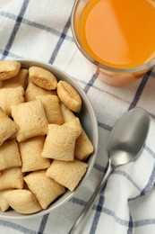 Photo of Bowl of sweet crispy corn pads and juice on kitchen towel, flat lay. Breakfast cereal