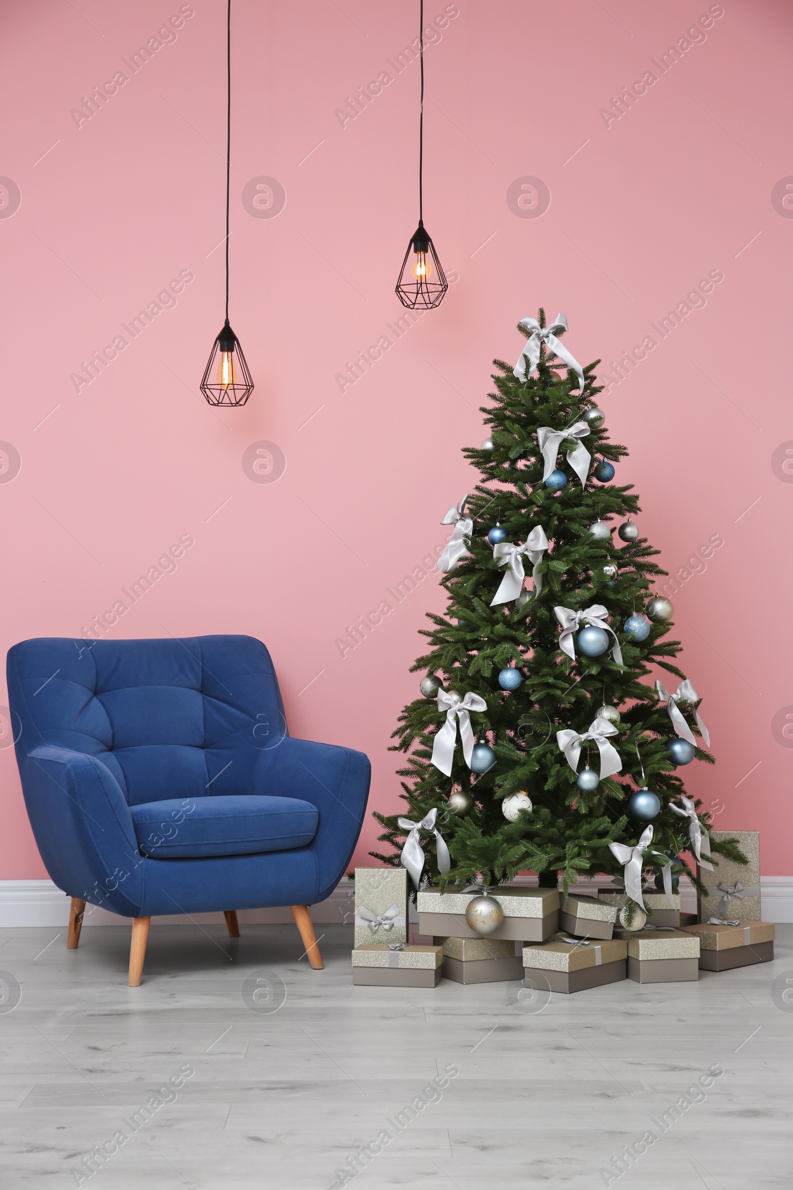 Photo of Stylish room interior with decorated Christmas tree