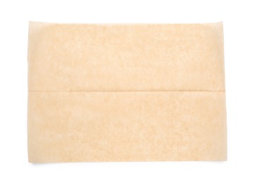 Photo of Sheet of brown baking paper on white background, top view