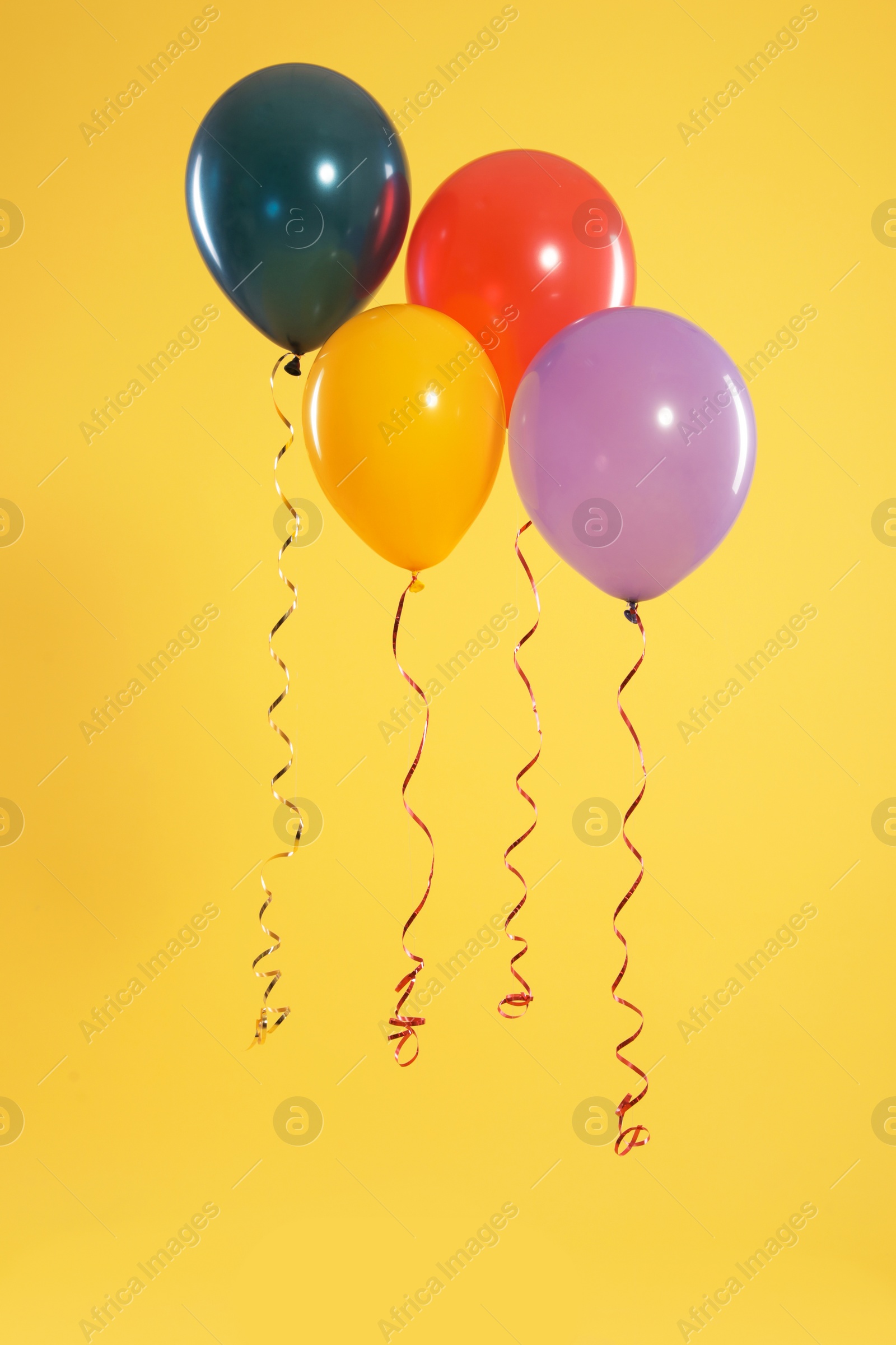 Photo of Bright balloons on color background. Celebration time