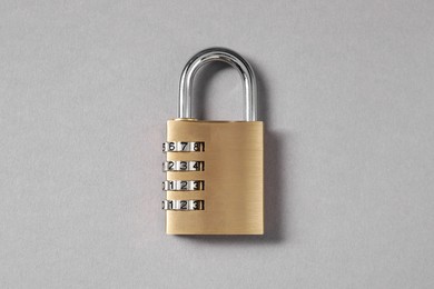 Photo of One steel combination padlock on grey background, top view