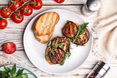 Photo of Delicious eggplant sandwiches served on white wooden table, flat lay
