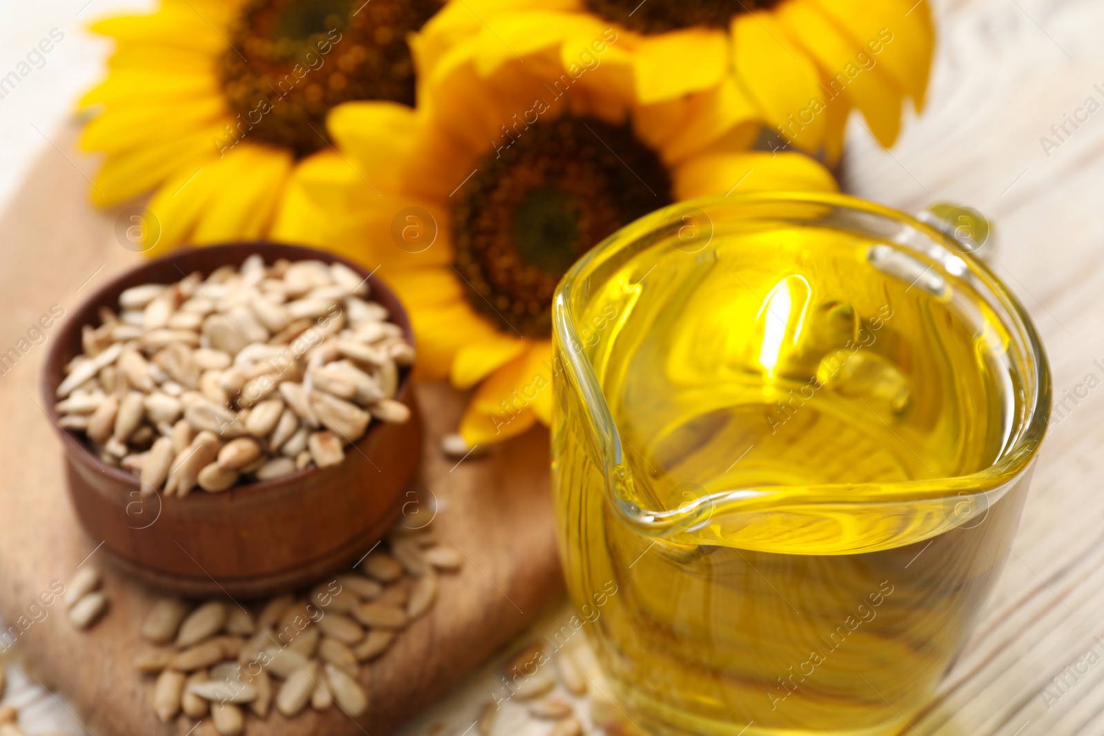 Photo of Sunflower oil in glass jug on table, closeup. Space for text