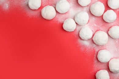 Snowballs on red background, flat lay. Space for text