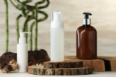 Bottles of face cleansing products on white table