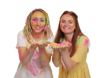 Photo of Women covered with colorful powder dyes on white background. Holi festival celebration