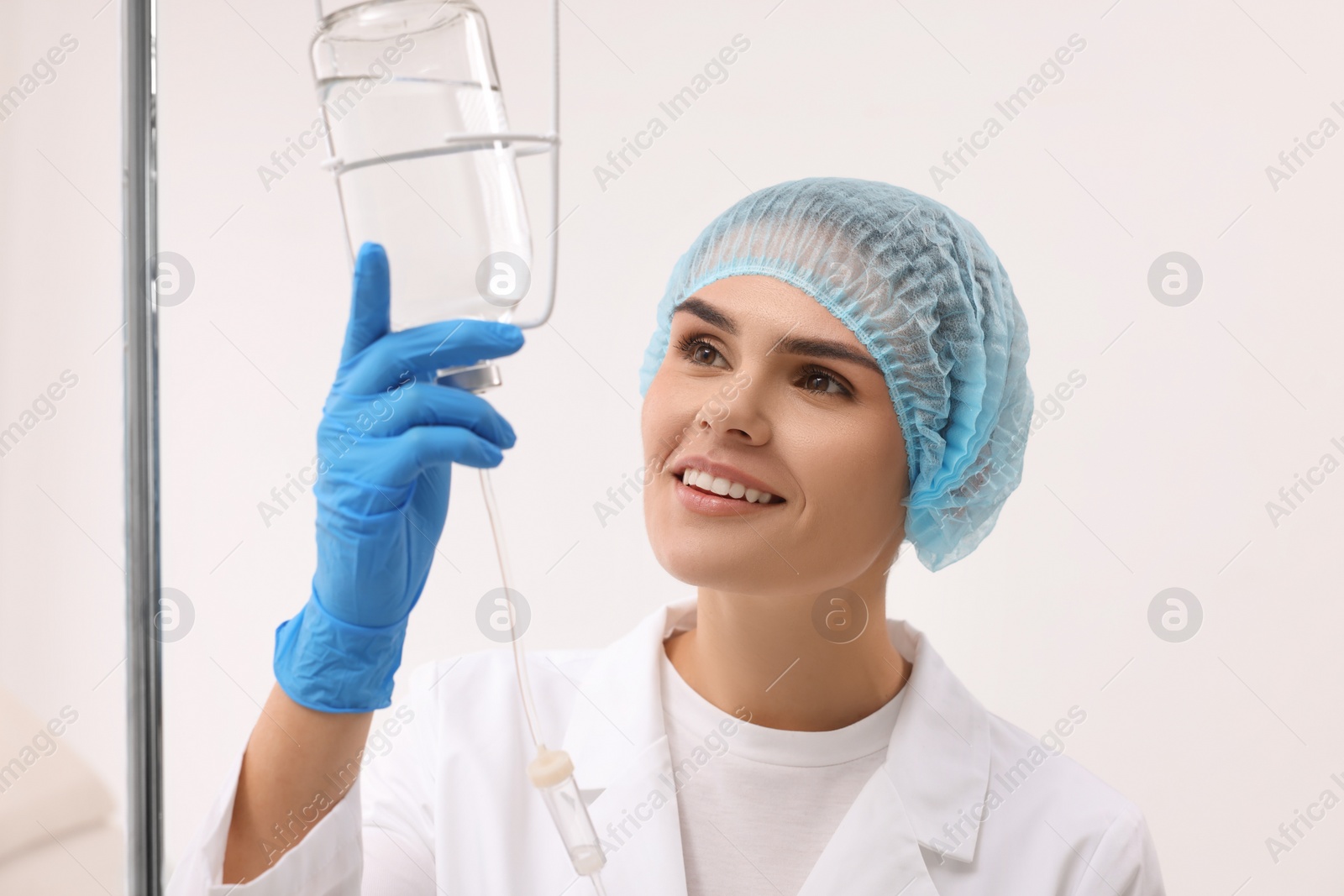 Photo of Nurse setting up IV drip in hospital