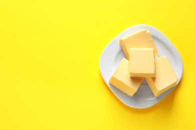 Photo of Plate with fresh butter and space for text on color background, top view