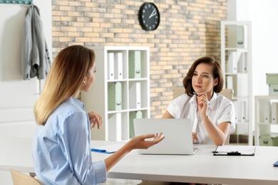 Human resources manager conducting job interview with applicant in office