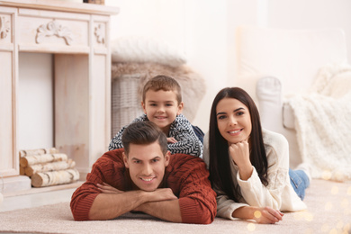 Photo of Happy family with little son spending time together at home. Winter vacation