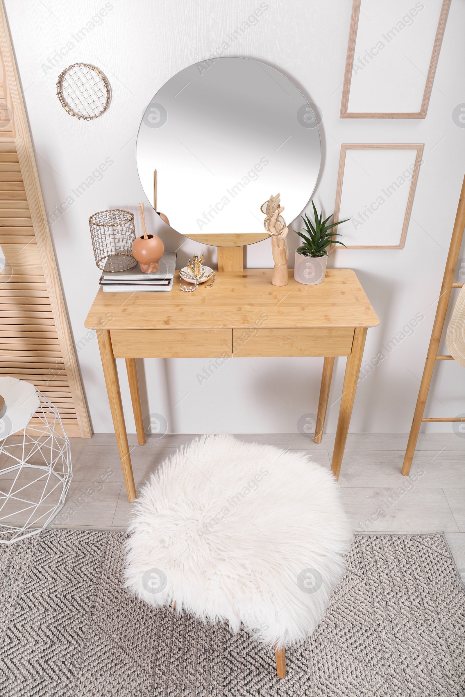 Photo of Modern wooden dressing table with mirror and stool in room