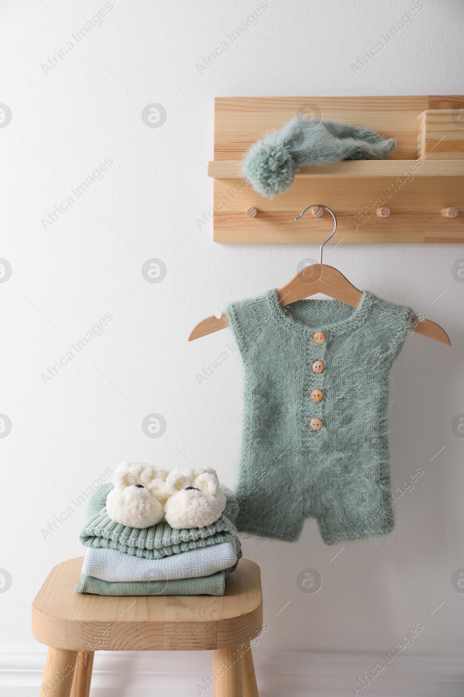 Photo of Cute children's clothes and shoes in room