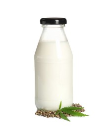 Photo of Glass bottle of hemp milk, leaf and seeds on white background