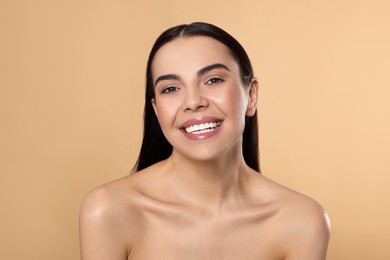 Portrait of attractive young woman on beige background. Spa treatment