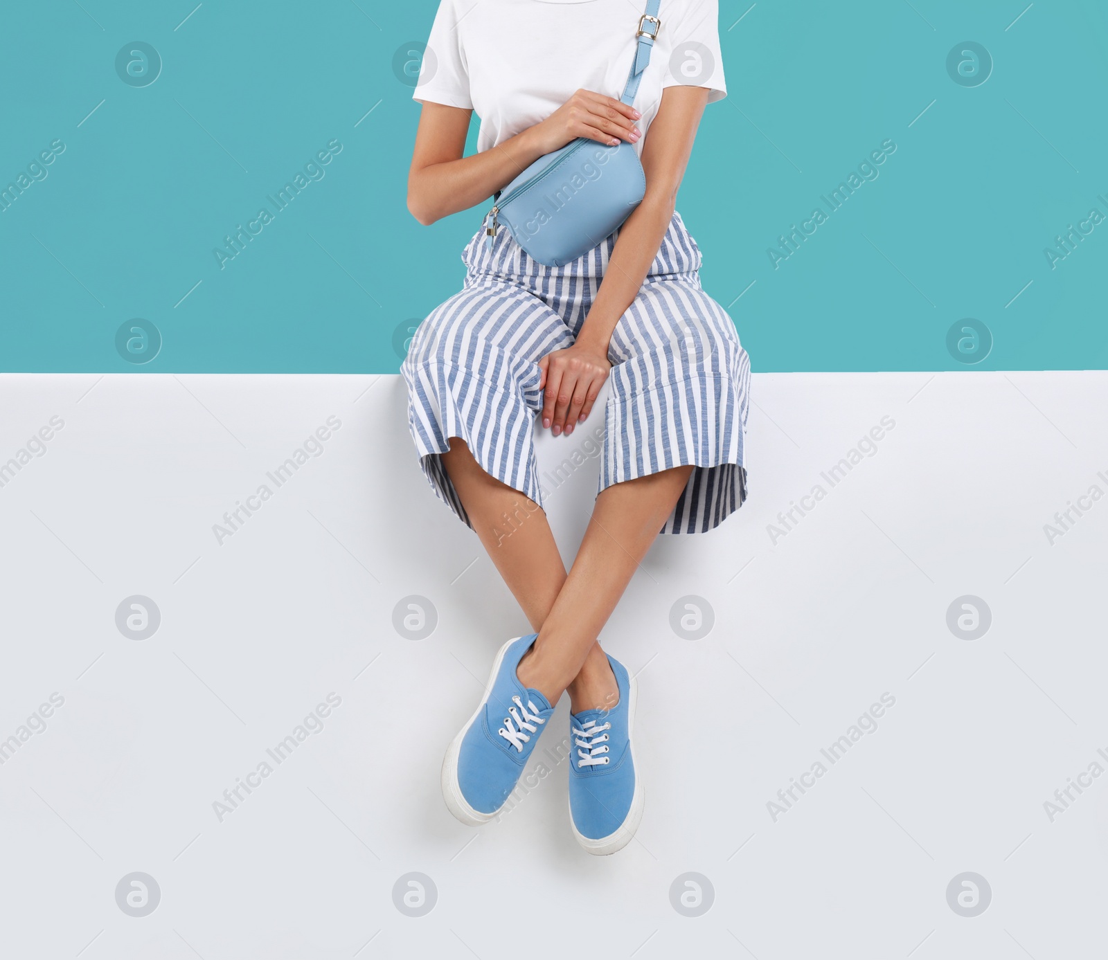 Photo of Woman wearing stylish shoes on color background, closeup