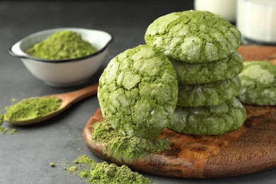 Photo of Tasty matcha cookies and powder on grey table, closeup. Space for text