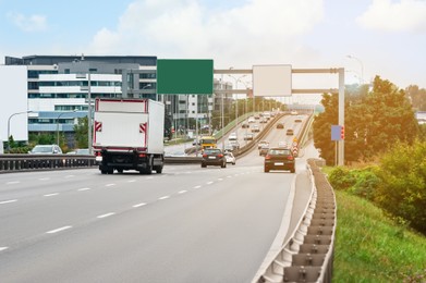 Photo of View of road, cars and buildings outdoors