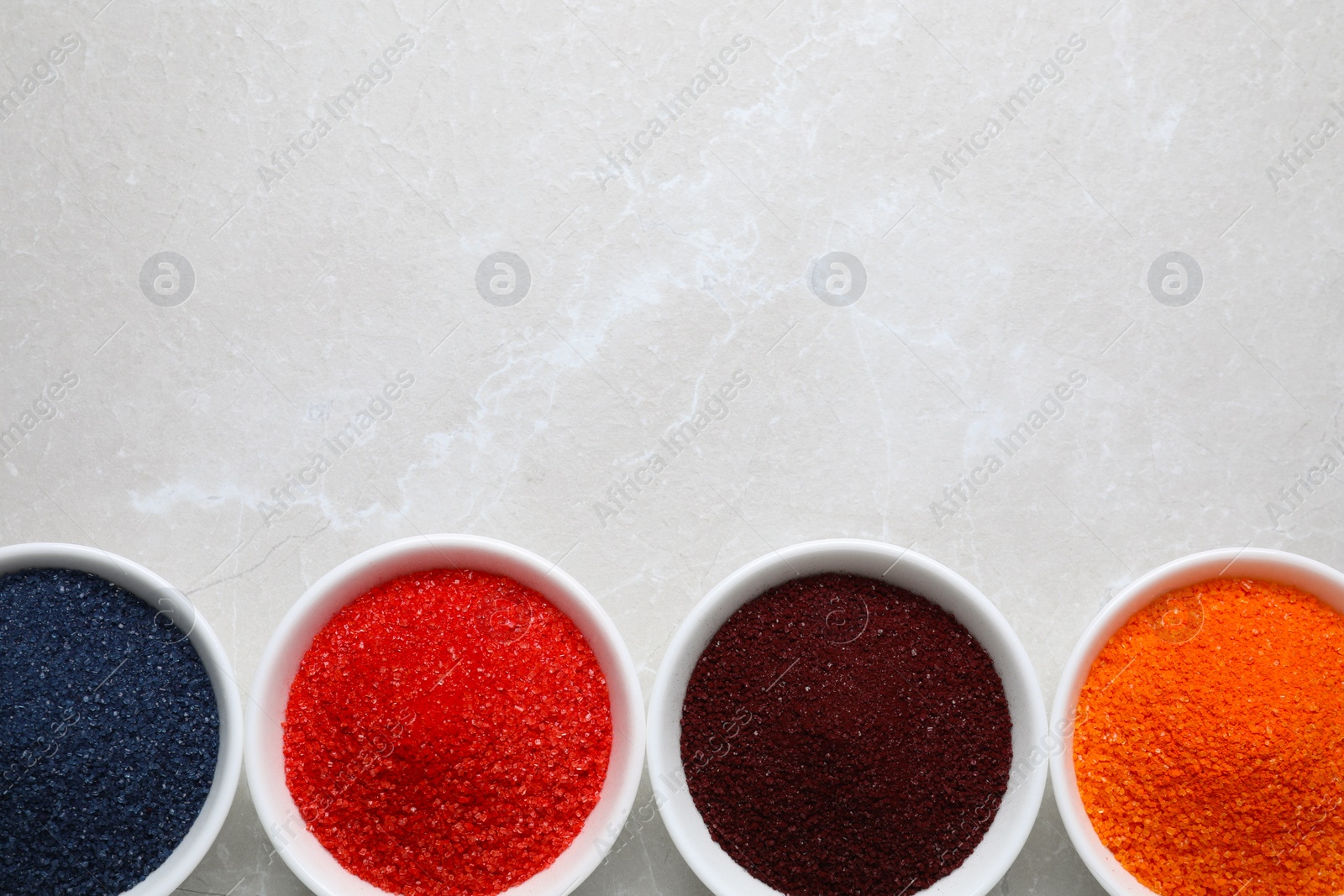 Photo of Many different food coloring on light grey marble table, flat lay. Space for text