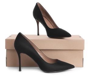 Photo of Pair of stylish shoes and cardboard box on white background