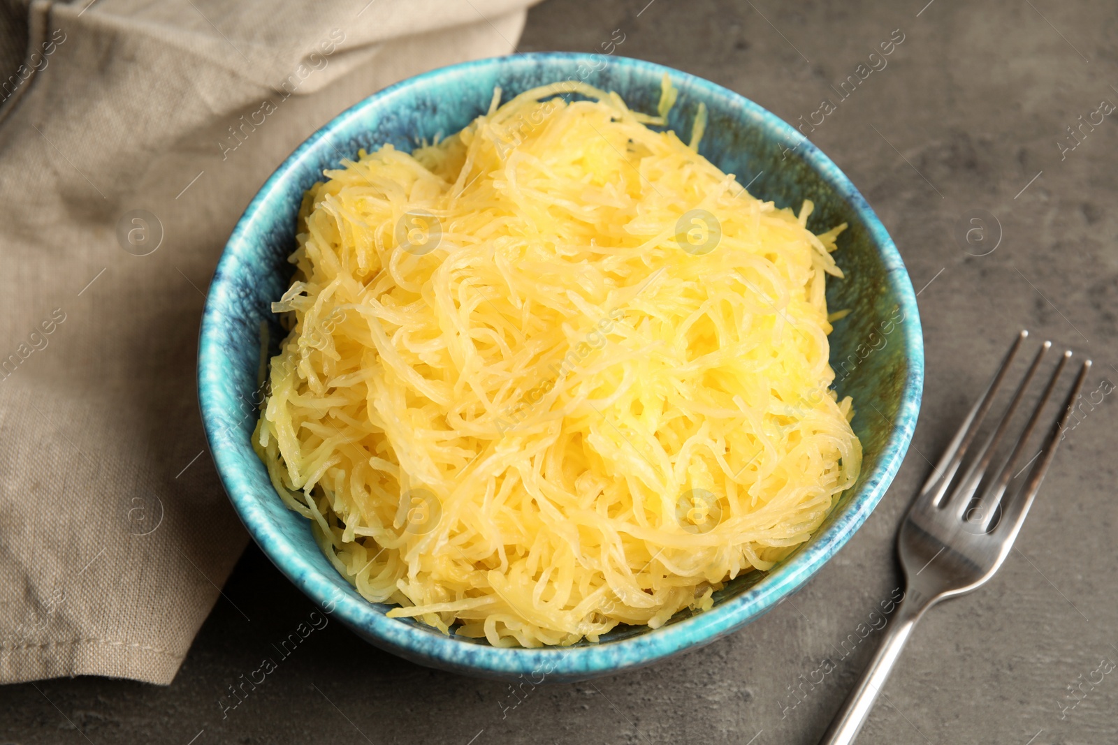 Photo of Cooked spaghetti squash in bowl on table