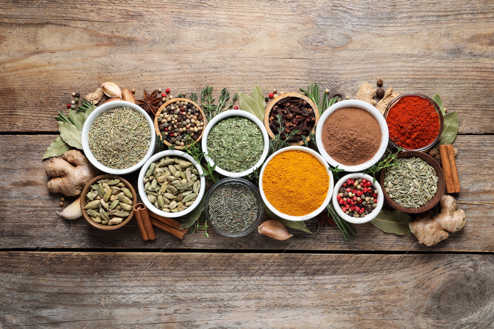 Photo of Flat lay composition with different natural spices and herbs on wooden table