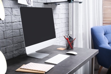 Comfortable workplace with computer on desk in home office