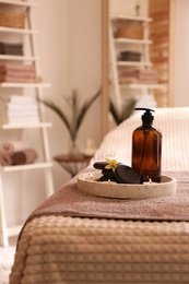 Beautiful spa accessories on massage table in room