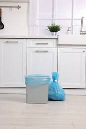 Photo of Plastic garbage bag and trash can in kitchen