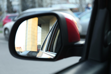 Photo of Side rear view mirror of modern car outdoors, closeup