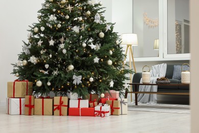 Beautiful Christmas tree and gift boxes in living room. Interior design