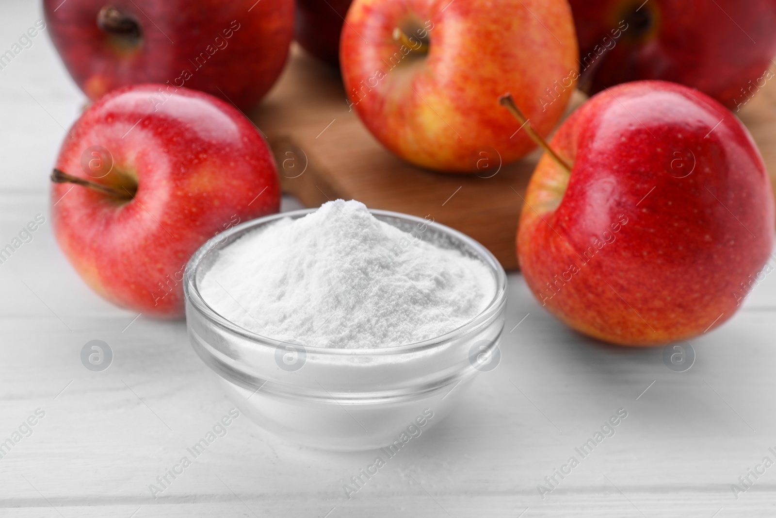 Photo of Sweet powdered fructose and fresh apples on white wooden table, closeup