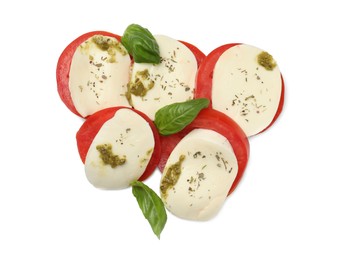 Photo of Tasty salad Caprese with mozzarella, tomatoes, basil and pesto sauce isolated on white, top view
