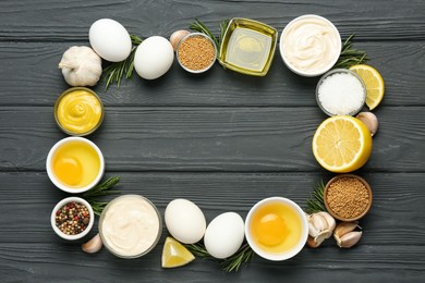 Photo of Frame made with fresh mayonnaise and ingredients on black wooden table, flat lay. Space for text