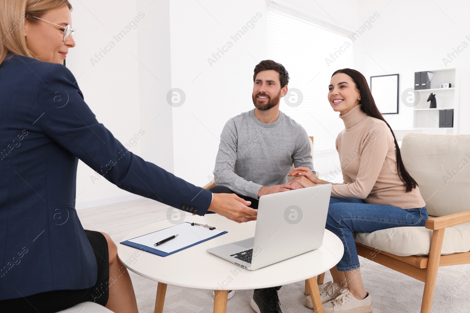 Photo of Real estate agent consulting couple in office