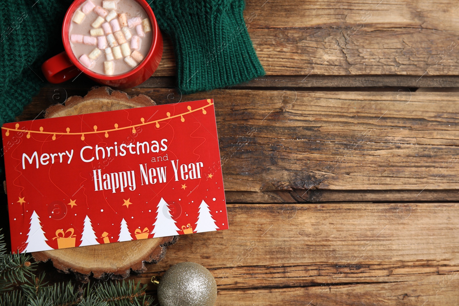 Photo of Flat lay composition with greeting card on wooden background, space for text. Christmas celebration