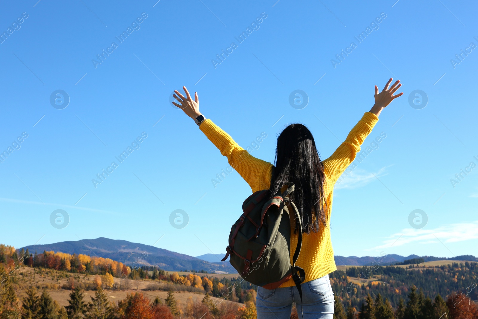 Photo of Female traveler feeling free in peaceful mountains